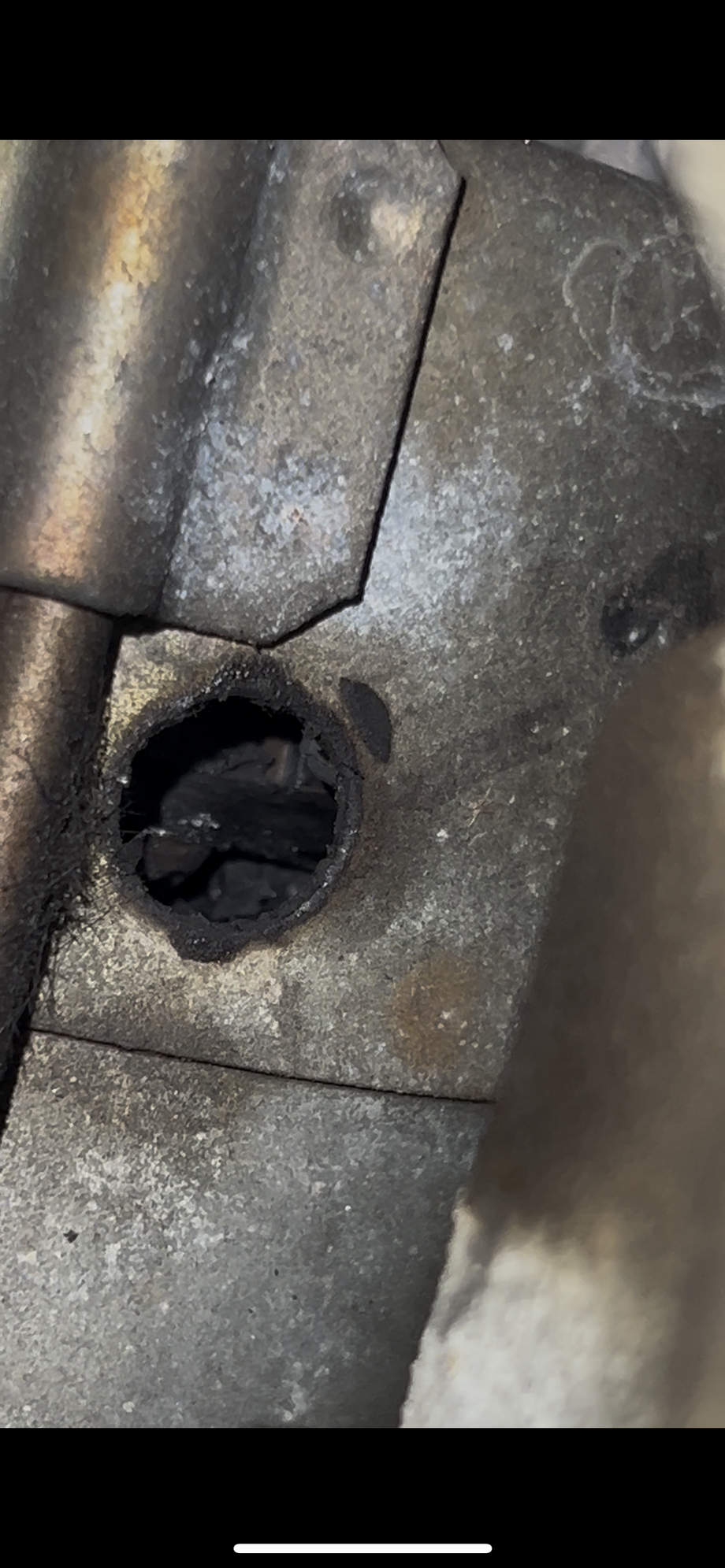 Charred black internals of starter motor through �peep hole� 
