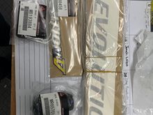 Evolution V rear badge now discontinued happy to have this and a few spares. Pedal pads, rear Mitsubishi badge. And door decals 