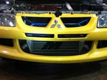 My yellow bumper that needs to be painted, with Cusco and Mishimoto goodies behind it.