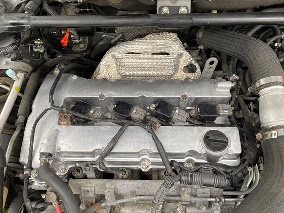 Aluminum valve cover freshly installed. A lot of the wire clips have to be fabricated.
