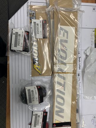 Evolution V rear badge now discontinued happy to have this and a few spares. Pedal pads, rear Mitsubishi badge. And door decals 