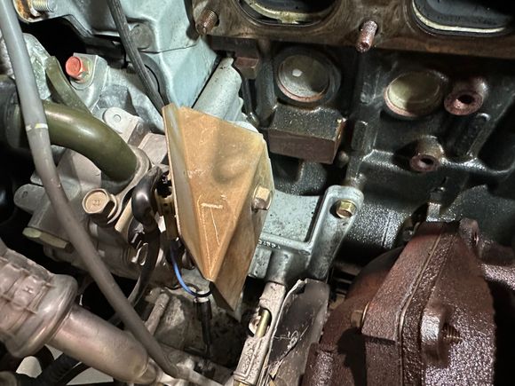 Heat shield I had to temporarily remove to access leftmost nut