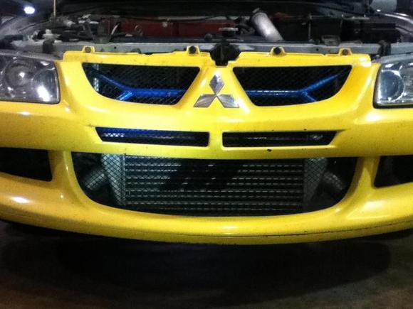 My yellow bumper that needs to be painted, with Cusco and Mishimoto goodies behind it.