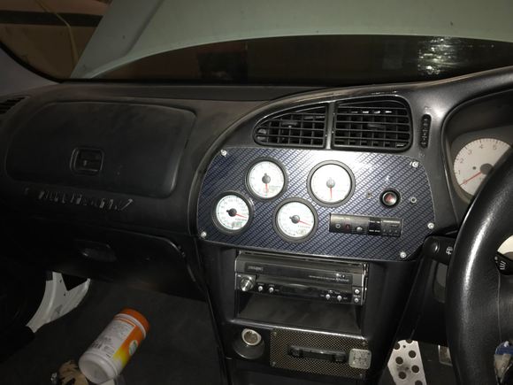 Thought I'd toss up a pic of the interior. The custom gages and carbon plate are growing on me. 