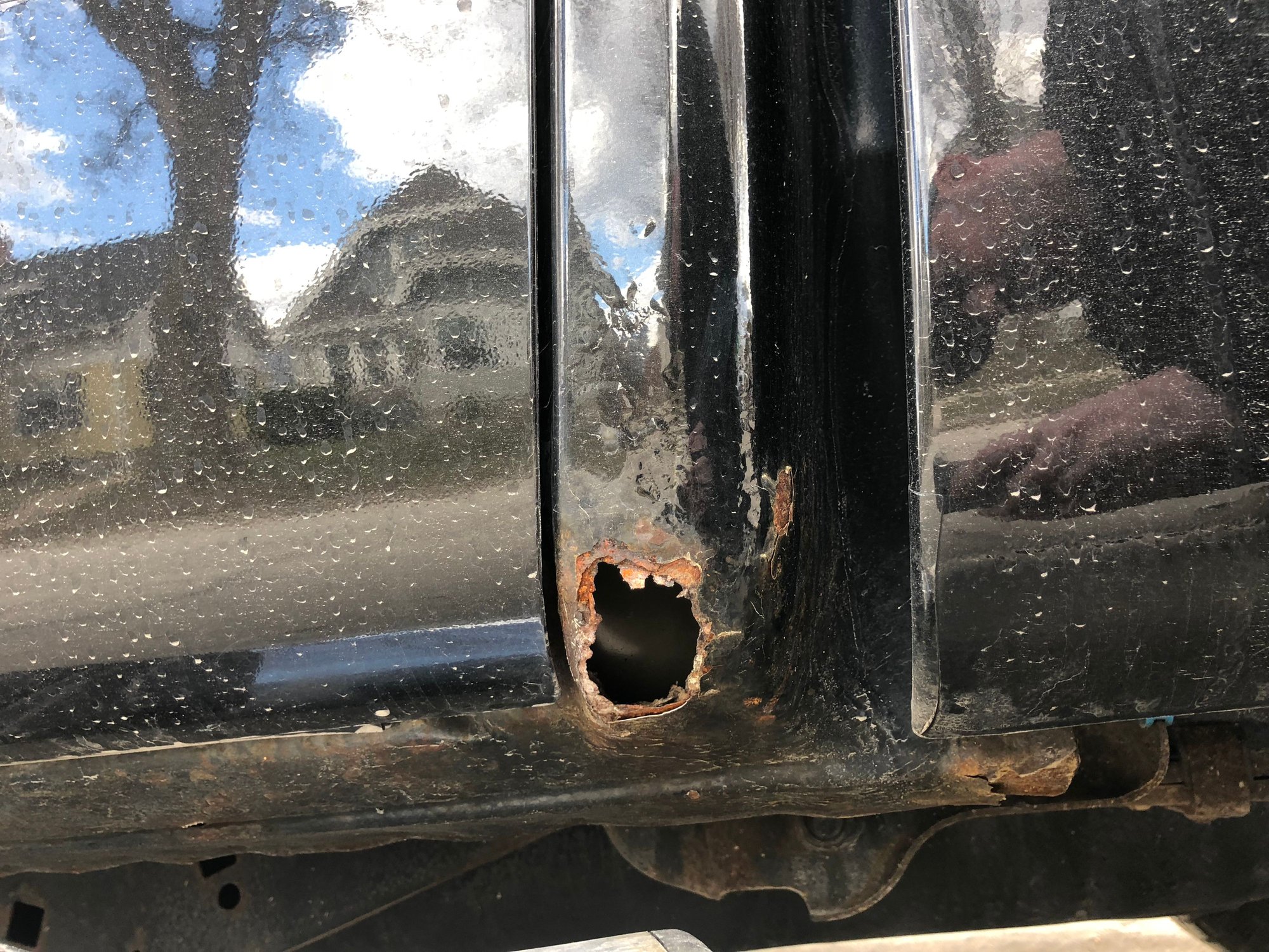 What to do about rust hole between rear door and side panel Ford F150