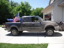 Mudding and 4wheeling for 4th of July.  Flag pole mount I installed in the bed.