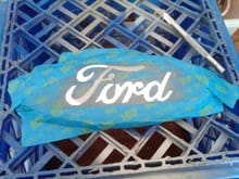 Cut-out the Ford portion with knife.
