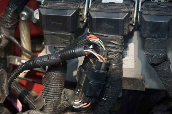 The PCM plug up front is spliced to signal the E-Fan controllers.  The Red/Yellow wire is accessory and the Grey/White wire is the A/C clutch.
