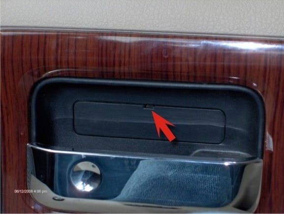 2 - Remove small cover panel behind door handle