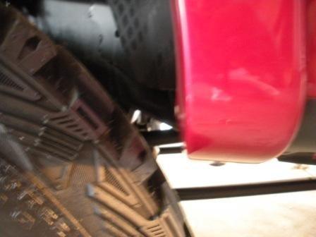 Lower Rear of Front Fender at Full Turn