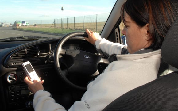 Drivers who cause death when looking at their mobile phones will face life in jail for the first time under Government plans to be revealed on Monday (file photo) CREDIT: ANNA GOWTHORPE/PA WIRE
