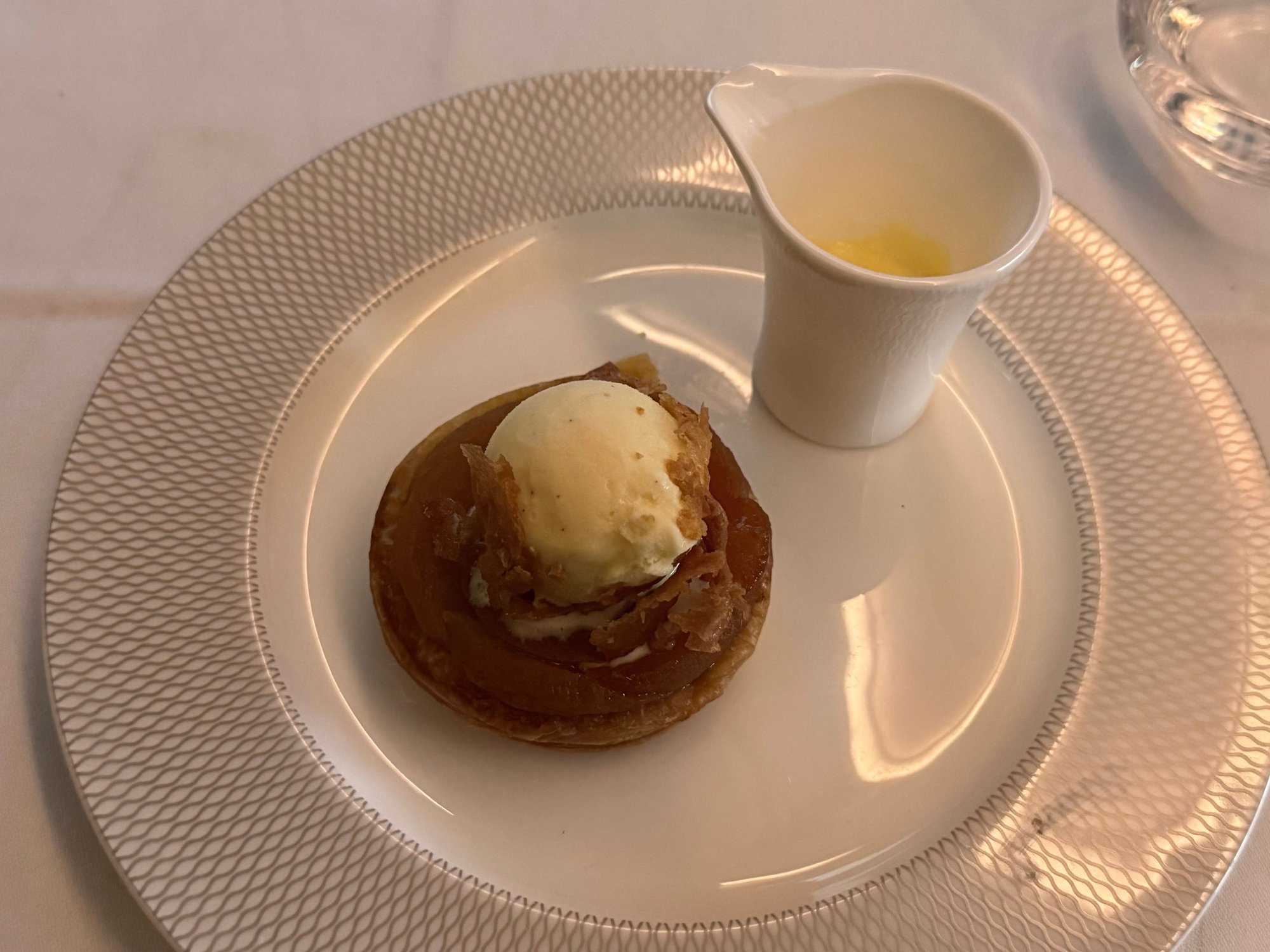 Tarte tatin was very good, but ice cream was low quality and icy, and the tiny amount of custard sauce was overheated so a bit curdled.