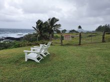 At least a dozen chairs like this are scattered just above the shore.