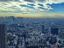 View of Shinjuku  ( NTT docomo tower ) to the left and Mt Fuji rising above the smog layer to the right with some clouds on top ( in reality the top of MT fuji was clearer than in the photo as it was above the brown smog)