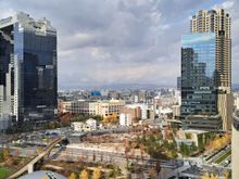 View from the  very nice roof garden at the top of Osaka station . Work going on in the foreground ( with a pedestrian bridge)-Dec 2025