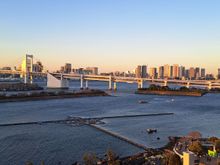 View of the rainbow bridge , tokyo tower and Tokyo skytree , with the statue of liberty ( to the left of the rainbow bridge you could see the approach road and part of the port ( car transporters docked)