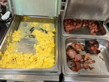 Burnt scrambled eggs and bacon at breakfast