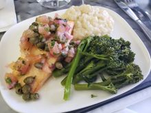 Pan Roasted Salmon Fillet served over fennel risotto with sauteed broccolini and topped with a tomato caper vinaigrette