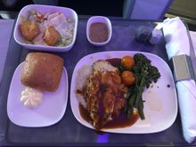 Clockwise from top: Caesar salad, rosemary chicken, whole grain bread with butter.  I let the steward know I have a shellfish allergy and he did not plate the harissa shrimp, he also prepared my tray first.