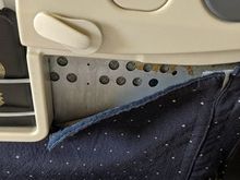 Ripped lining of the back of seat in front of mine