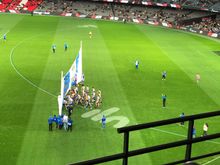 North Melbourne running through their banner