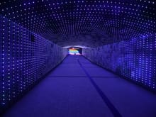 Tunnel under the racetrack with coloured steps at the end. The tunnel lights changed so it seemed like a wave