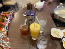 Herbal sour plum , red apple juice , glasses & tumbler of iced water