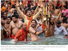 Hindu holy men, not following COVID-19 precautions, in the Ganges River earlier this month in a ritual called Shahi Snan, or royal bath. 