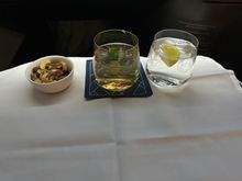 Post-takeoff service started w/ warn nuts and choice of beverage(s)