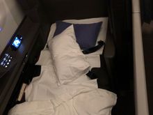 The flight attendant woke me up about 2 hours out of New York JFK. It was only now that I realized the suite actually had a door, and I rushed to get pictures before they cleaned up the bed!