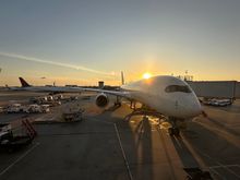 Beautiful evening at ATL with an A350 at the gate, a 767-400 taxiing out behind, and another A350 departing 27R during sunset. 