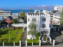 Across the street with views of the water and mountains in the distance.