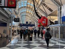 Gate signs at ORD with the Chicago Blackhawks logo to celebrate the hockey teams 100th anniversary. The replica of Sue the dinosaur also has a Blackhawks jersey. Goes along with United's 100th anniversary.