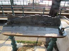 An ornate bench by the tram tracks which in turn run along the river in that part of town