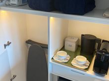 Directly left of the entry is the closet which has the iron+board, Kimpton's signature yogamat, robes + slippers, kettle, Nespresso machine