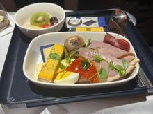 Crew were apologizing as they said this was the first day of a new service in Premium Econ ((LHR-MSP). 
Instead of the same pre-landing snack as econ there was a choice of a charcuterie plate (3 cheeses, 2 meats, pickled onion, gerkin, caper). 
Drinks service was constant (and served in glasses) throughout the flight and the snack basket came round at least 4 times. 
Definite improvement!