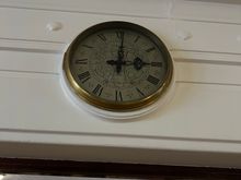 One of the clocks, all of which are stopped at one minute past three.
