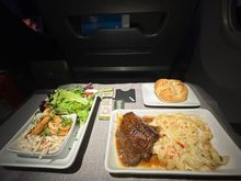 Shrimp, salad, short rib and a choice of bread basket, warm nuts and olives served. MIA-LAS on American.