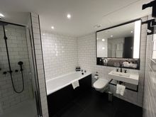 Deluxe King Room bathroom (full sized-tub, but stall shower was on the small side) 