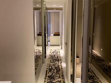 Interior hallway to bedroom, lined with wet bar room and main bathroom.