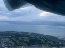 Towering cumulus with precipitation (and some spots of virga: precipitation that evaporates before it reaches the ground)  on approach into DUB on Aer Lingus flight. You can also see three ferries coming out of the harbour.