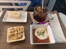 Inexperienced young flight attendant served cold nuts with a drink and bruschetta appetizer just 17 minutes after take off on a 6 hour flight to Hawaii.