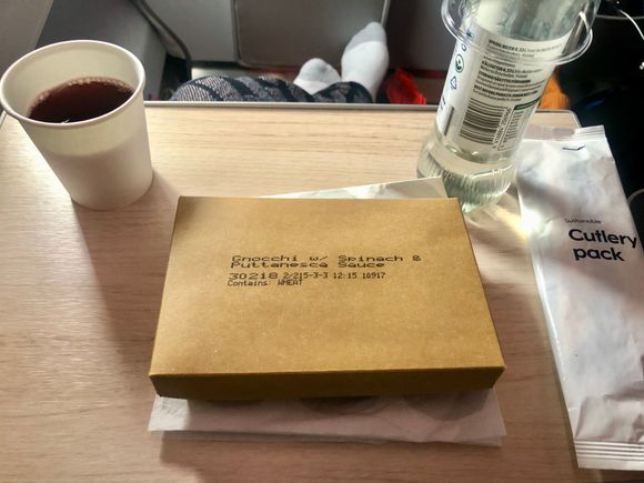 Premium Economy Lunch, gnocchi with spinach and tomato sauce