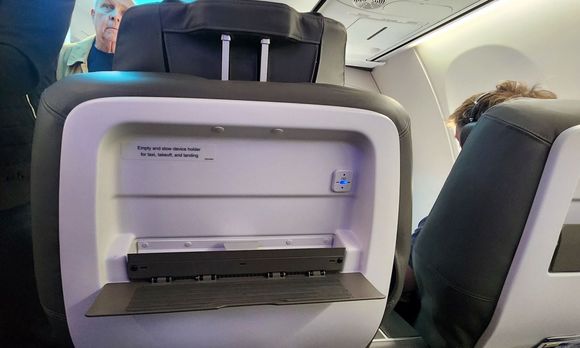 Device holder. The small metal piece in the middle slides up to hold the top of your device.