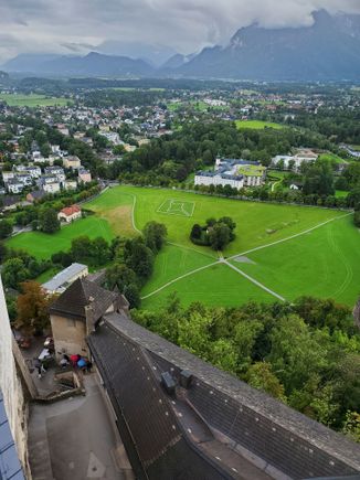 The thick dark clouds provide a perfect backdrop to the lush greenery in the foreground
