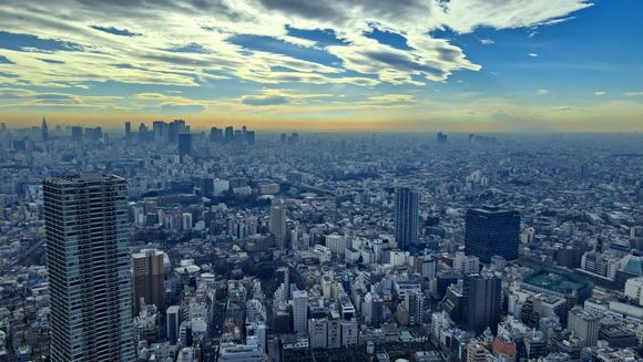 View of Shinjuku  ( NTT docomo tower ) to the left and Mt Fuji rising above the smog layer to the right with some clouds on top ( in reality the top of MT fuji was clearer than in the photo as it was above the brown smog)