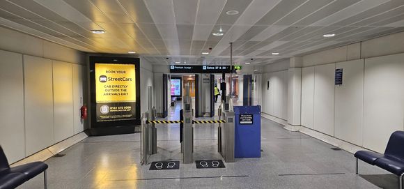 Newer biometric gates down the stairs before gate 37