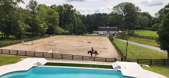 My cousin riding her newest horse and teaching him to jump. His racing name was News Item.