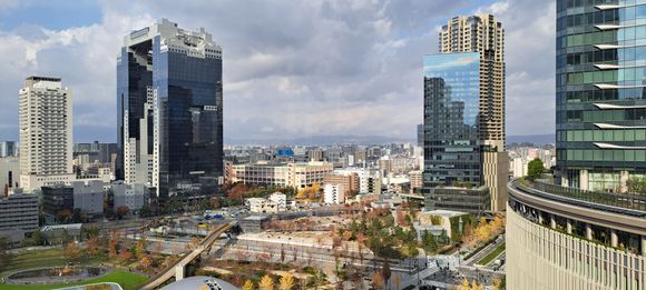 View from the  very nice roof garden at the top of Osaka station . Work going on in the foreground ( with a pedestrian bridge)-Dec 2025