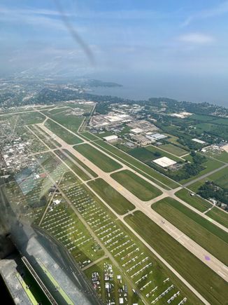 Runway 18/36 at Oshkosh, note the coloured dots on the runway that aircraft are directed to land on during the mass arrivals days. Also the lines of parked visiting aircraft.